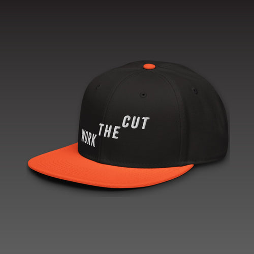 Climb Flat Bill in orange visor, WORK THE CUT climbing across the front in white embroidery, seen from the side