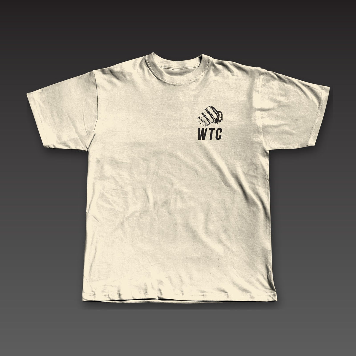 The Jab Tee in oatmeal, a fist over WTC on the left chest