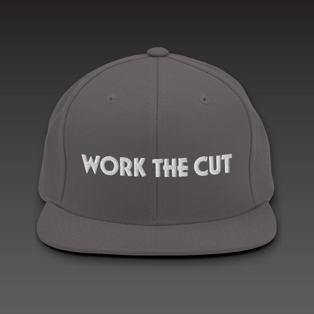 One-Line Flat Bill in dark grey / white, WORK THE CUT in one line of white embroidery across the front