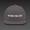 One-Line Flat Bill in dark grey / white, WORK THE CUT in one line of white embroidery across the front