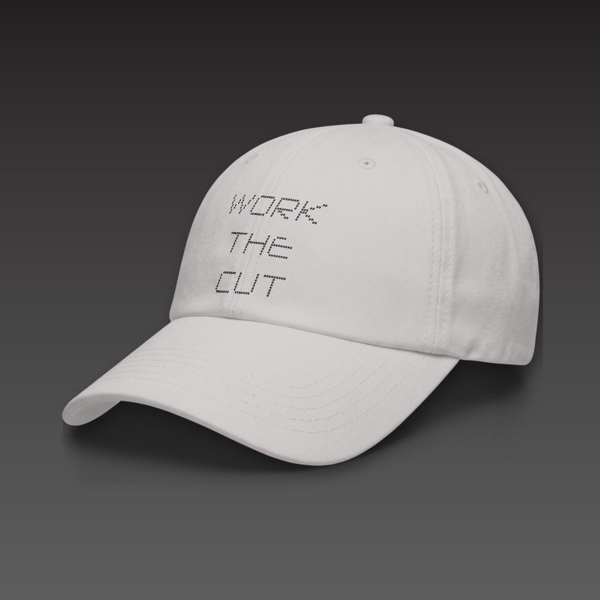Scoreboard Dad Cap in light grey, WORK THE CUT stacked in black scoreboard dots on the front, seen from the side
