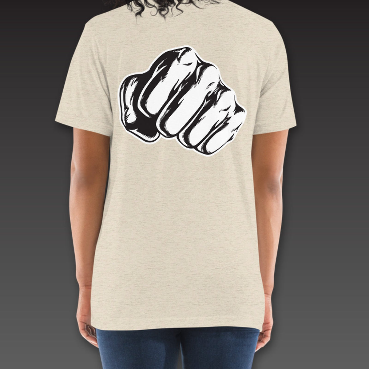 Women's Haymaker Tee in oatmeal, a single fist across the full back