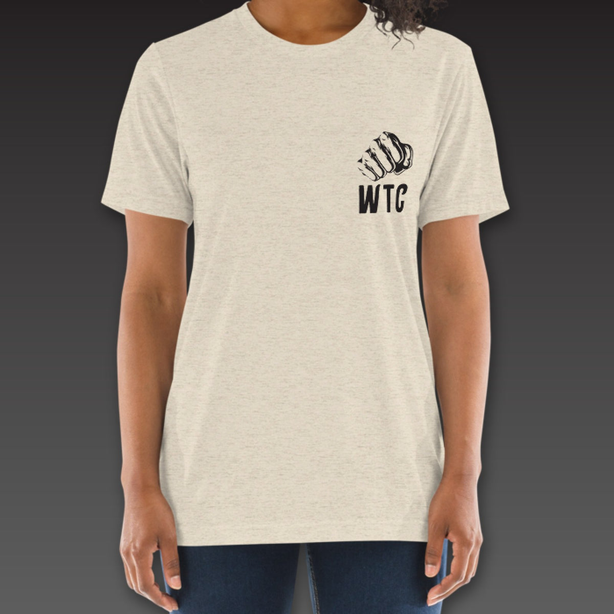 Women's Jab Tee in oatmeal, a fist over WTC on the left chest