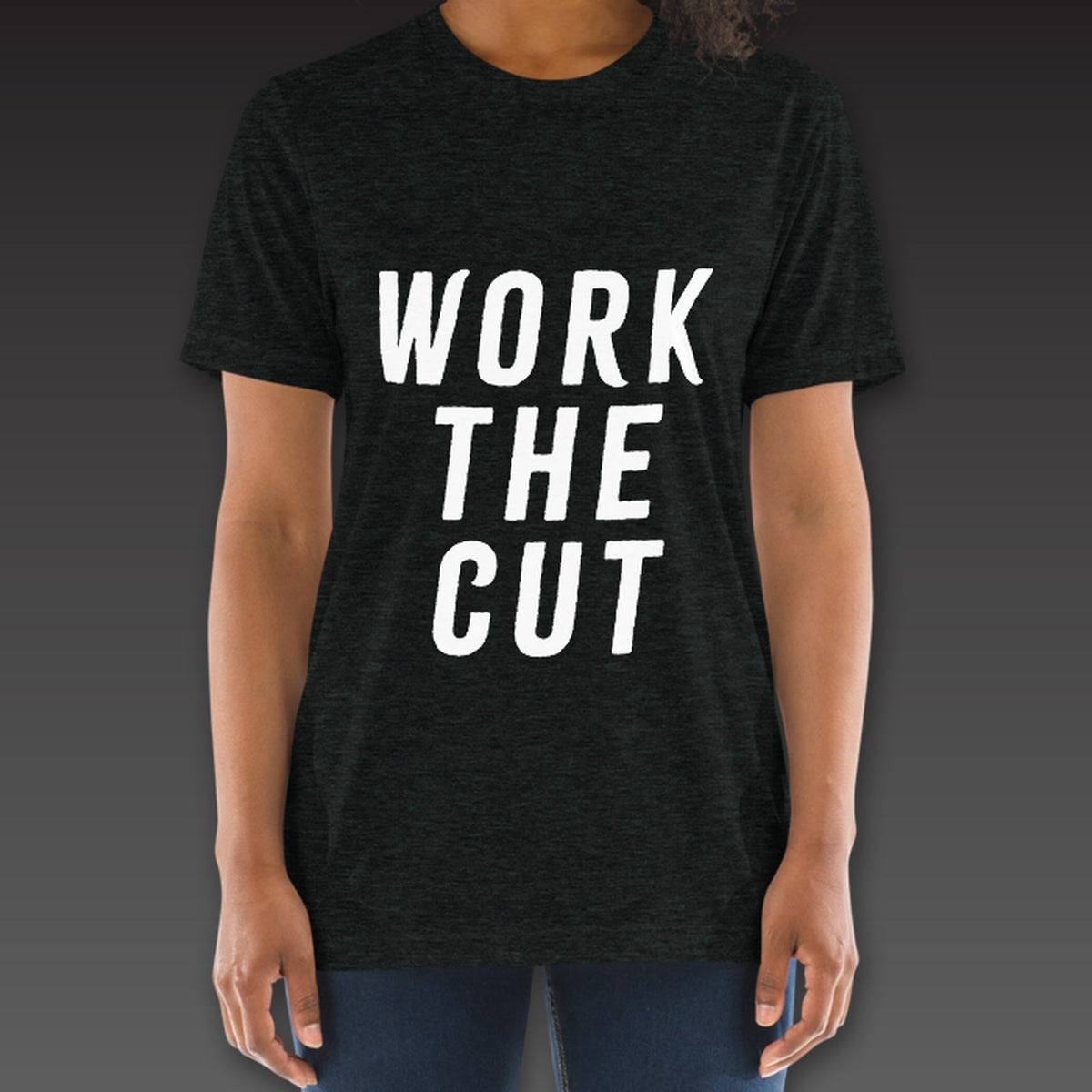 Women's Headliner Tee in charcoal black, Work the Cut stacked down the whole front
