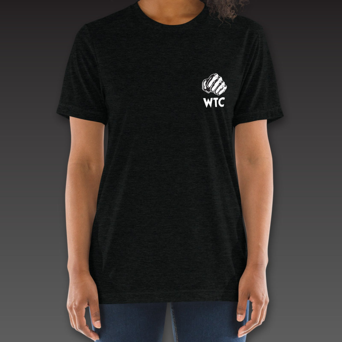 Women's OG Tee in black, a fist over WTC on the left chest